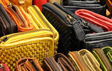many leather zip wallet created by hand by the skilled craftsman for sale in the leather shop clipart