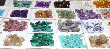 market stall selling colorful gemstones for healing using the therapeutic power of crystals clipart