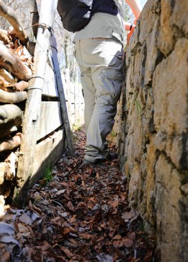 Soldier in uniform inside a narrow trench during the war clipart