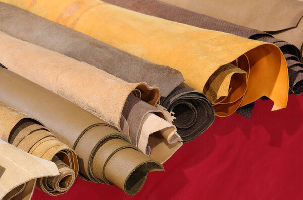 rolls of leather for handcrafted clothing creations for sale in tailoring shop