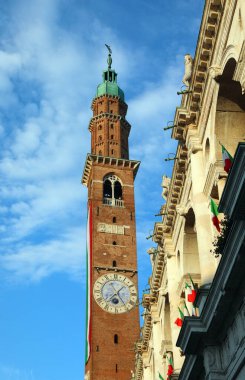 Vicenza, VI, Italy - May 10, 2024: Tower called Torre Bissara most famous landmark of the city with big italian flag clipart