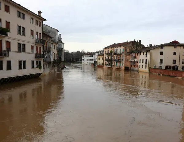 stock image Flooded river during a flood and the houses of the population lapped by the water in the city