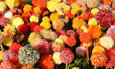 flowers made with numerous soft pompoms made with colorful soft wool threads clipart