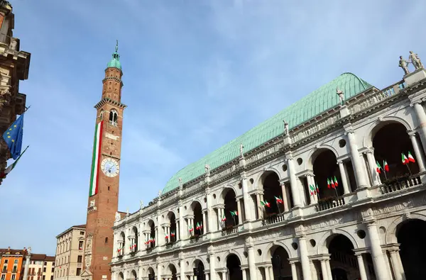 stock image Vicenza, VI, Italy - May 10, 2024: Tower called Torre Bissara most famous landmark of the city with big italian flag