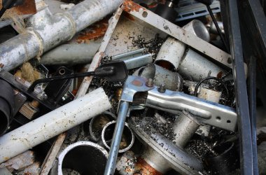 Scrap metal pieces, cut pipes and ferrous shavings in a scrap metal yard for material recovery clipart