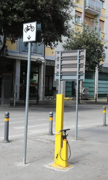 stock image metal bicycle repair station with an air pump and tools on a city