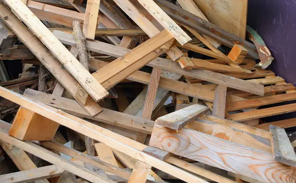 stock image Used wooden pieces planks and pallets in the wood recycling container at the landfill