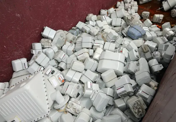 stock image Heaps of used methane gas meters dumped haphazardly after removal and ready for landfill disposal