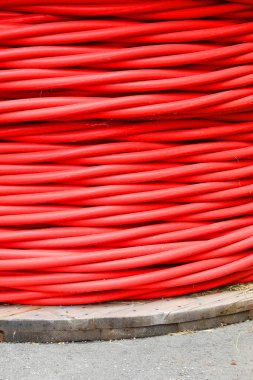 spool of red high-voltage insulated cable for transmitting electricity from the power plant to the main substations. clipart
