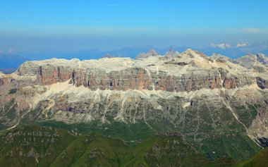 Sass Pordoi mountain and Piz Boe peak on the right with small  alpine hut above as seen from the Marmolada in the Italian Alps Dolomites clipart