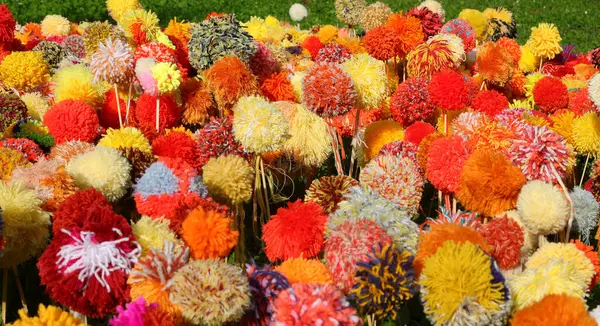 stock image background of many pom poms made with colorful wool threads that look like real flowers blooming in spring