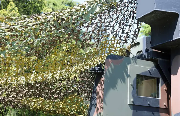 stock image military tent with camouflage fabric to camouflage among the vegetation during the exercise in a training camp for soldiers