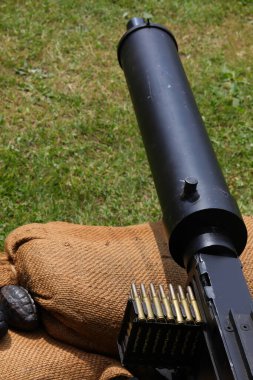 water-cooled machine gun used during World War I with sandbags during a historical reenactment clipart