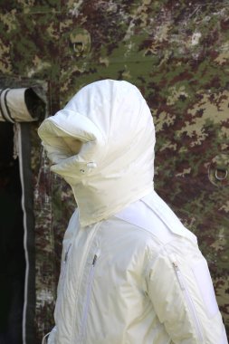 white winter camouflage uniform for warfare during the winter on icy or snowy terrain worn by a soldier during a military exercise clipart