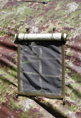 windows of the modern military tent with camouflage fabric  during the exercise in a training camp clipart