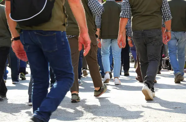 stock image many legs of people marching through the streets of the city in protest during a peaceful demonstration