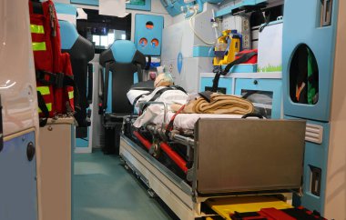 Tam teçhizatlı bir ambulansın içinde tüm tıbbi ekipmanlar ve acil bir durum sırasında sedyede yaralı bir adam vardı.