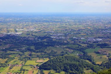 view from above of the italian plain called po valley with city houses and cultivated fields clipart