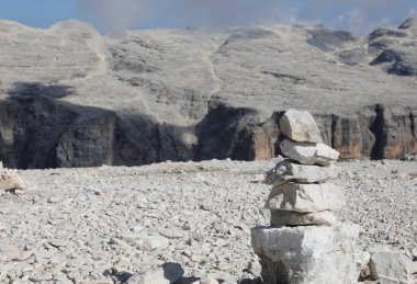 pile of stones called cairn in the high mountains symbolizing a prayer or a sign of orientation in the european alps clipart