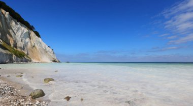 fantastic view of the white sea due to the Calcium Carbonate sand and the cliff in the island in the south of Denmark called MONS KLINT clipart