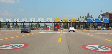 Mestre, VE, Italy - July 9, 2024: large motorway toll booth for toll collection with preferential lanes for payment with electronic radar clipart