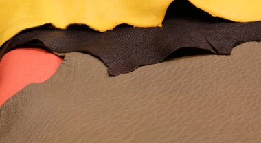 background of many colored leather scraps of various sizes after industrial tanning process clipart