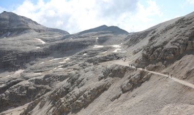 rocky trail leads to the peak of the mountain called Piz Boe in the Sasso Pordoi mountain range in the Dolomites mountains in the European Alps in Italy during the summer clipart