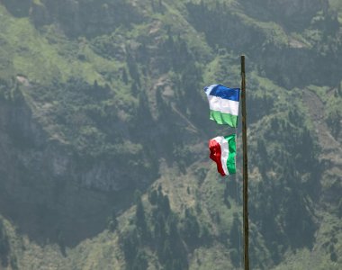 flag of Italy and flag of Ladinia the  Alpine region in the Dolomites mountain range of Northern Italy clipart