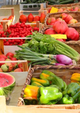 Freshly picked green peppers tomatoes and onions for sale at the farmers market clipart