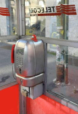 Milan, MI, Italy - November 2, 2024: old coin-operated telephone from a disused Italian telephone booth of the TELECOM ITALIA company clipart