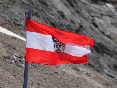 Austrian historical flag with the eagle symbol and the horizontal bands colored red and white clipart