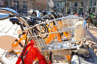 many metal bike racks for rented bicycles with city bike sharing system clipart