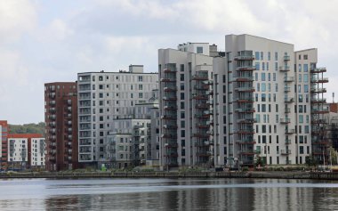 very Tall skyscrapers of the residential and office complex by the sea clipart