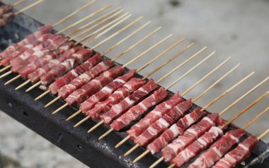 Raw sheep and lamb skewers called ARROSTICINI, a typical dish of Italian cuisine from the regions of Molise and Abruzzo clipart