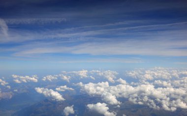 aerial view from the window of an airliner with white clouds below clipart