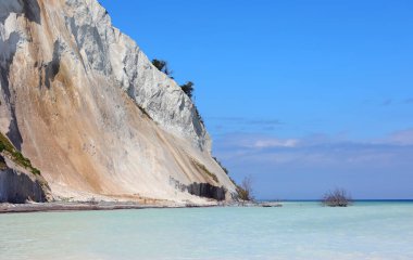 white cliff made of calcium carbonate eroding due to natural elements by the sea clipart