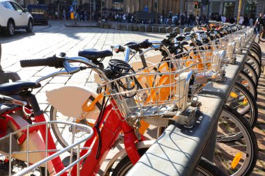 Many bicycles available for rent to explore the city without parking problems clipart