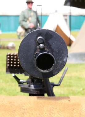 close-up of the barrel of the large, black, antique machine gun used by Italian army soldiers during World War I. clipart