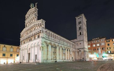 Eski kilise San Michele al Foro 'da dekore edilmiş bir cephe ve Orta İtalya' nın Lucca Toskana bölgesinin tepesinde bir melek heykeli.
