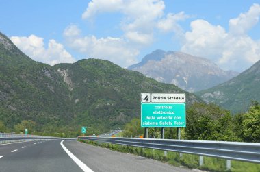 Carnia, UD, İtalya - 1 Mayıs 2025: otoyol işareti İtalyanca 'da hız kontrolü uyarısı içeriyor. Otoyol polisinin özel ders sisteminde ihlalleri tespit etme konusunda uyarısı var.