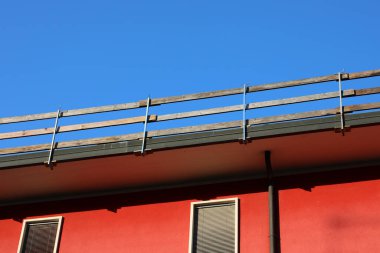 Dayanıklı koruyucu bariyerin ahşap kalasları işçilerin güvenliği için sıkıca yerleştirildi. Dairenin çatısında bakım sırasında insanlar olmadan düşmesinler diye.