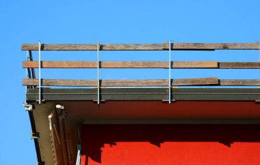 Ahşap kalaslarla düşme koruma bariyeri çatıdaki çalışma alanını işaret ediyor.