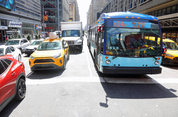 New York, NY, USA - August 24, 2025: very busy avenue with cars yellow taxis and buses line up at rush hour
