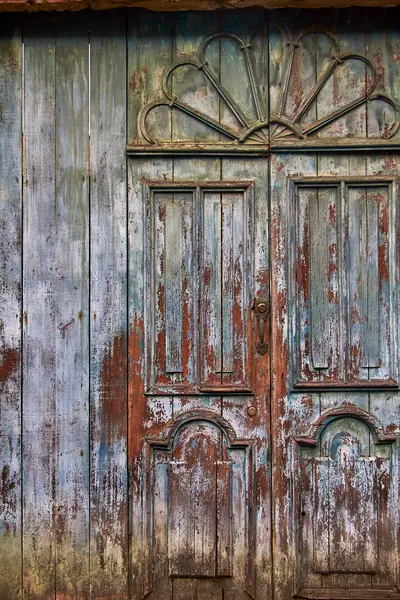 Transport yourself to a bygone era with this captivating image featuring a background in the shape of an old or colonial-style door, adorned with worn colors that tell stories of time and history, evoking a sense of nostalgia and intrigue.
