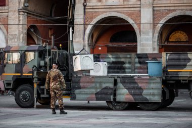 a military man loads a car with cargo. High quality photo