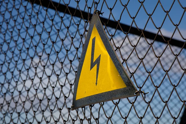 electrical hazard sign on the grid. High quality photo