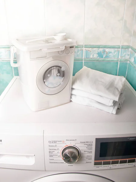 Containers for storing washing powder for different fabrics on a washing machine.