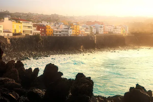 stock image Colorful buildings on ocean coastline during moody sunset, Porto de la Cruz - Punta Brava, Tenerife, Spain