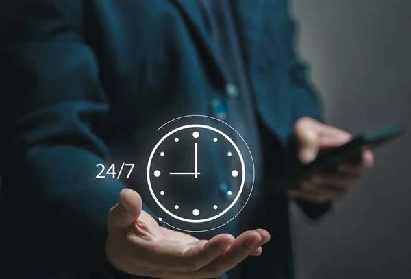 Concept of 24x7 hour MA. Businessman holding a watch icon in his hand. standard service, non-stop and full Maintenance. Business contact center helpdesk for assistant help. onsite service.