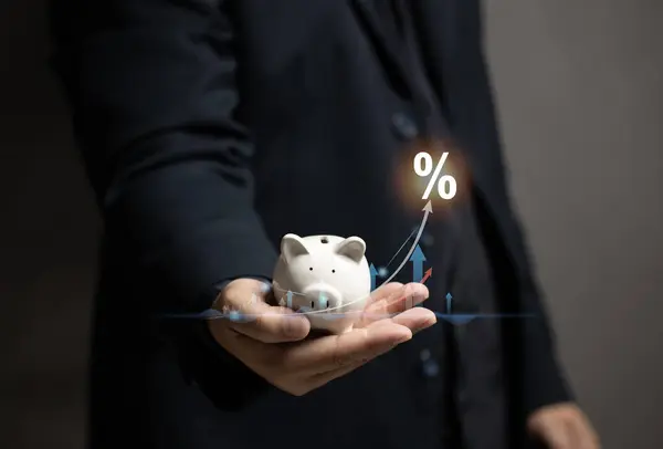 Man hold the piggy bank and virtual graph stock on his hand. Save money for the future. Finance investment wealth for family. Planning growth money and earn interest from bank.